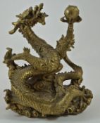 A Chinese bronze dragon holding a flaming pearl, on a base of clouds, 18.