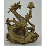 A Chinese bronze dragon holding a flaming pearl, on a base of clouds, 18.