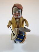 A German Schuco clockwork figure modelled as a clown drummer with key, 11.
