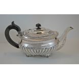 A Georgian silver teapot, marks very worn, circa 1821, of rounded rectangular outline,