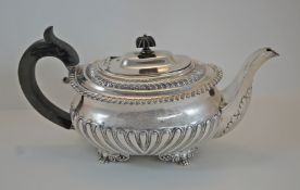 A Georgian silver teapot, marks very worn, circa 1821, of rounded rectangular outline,