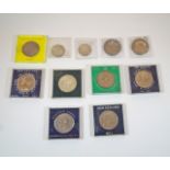 A collection of commemorative coins to include a 1951 crown and various others