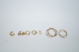 A collection of five pairs of earrings,