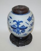A 19th century Chinese porcelain ginger jar painted in blue with various objects, 24cm high,