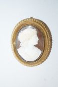 A Victorian shell cameo brooch, of a classical female in profile to a bead and wire work frame, 5.