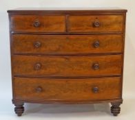 A Victorian mahogany bowfronted chest of two short and three long drawers with turned handles on