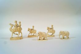 Three late 19th century Indian carved ivory chess pieces, in the form of two figures on a camel, 7.