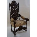 A Victorian oak armchair with elaborately carved back,
