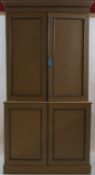 A painted mahogany two tier standing cupboard with two cupboard doors above a further two doors on