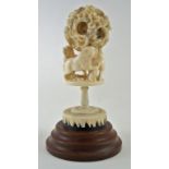 A late 19th century Chinese carved ivory concentric ball and stand,