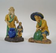 Two Chinese mudman figures, one of a fisherman with lobster pot, 11cm high,