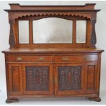 An early 20th century oak Art Nouveau style sideboard with triple mirrored back above two drawers,