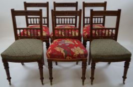 A set of six late Victorian oak chairs with stuffover seats,