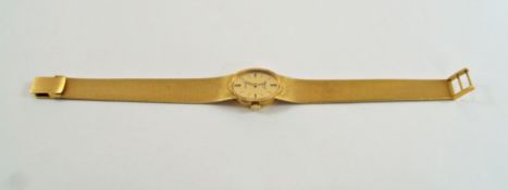 A Chopard lady's bracelet watch, marked 750, the oval dial with batons to the quarters,