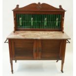 An Edwardian mahogany wash stand, the raised tiled back in Art Nouveau style above a marble top,