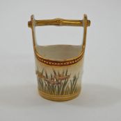 A late 19th century Japanese earthenware miniature pale, painted with iris on a gilt dot ground, 6.