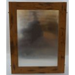 A wall mirror in a pine frame, 26.