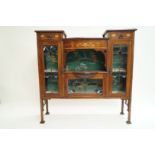 An Edwardian mahogany display cabinet with Art Nouveau style marquetry and stained glass panels,