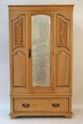 An Edwardian stripped mahogany wardrobe with one mirrored door above one drawer, 183cm high,