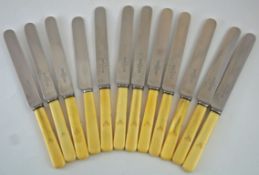 A set of twelve early 20th century knives, with ivory handles, and stainless steel blades,