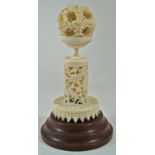 A late 19th century Chinese carved ivory concentric ball and stand, pierced and carved with dragons,