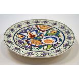 A Poole pottery plate decorated by Susan Russell with stylised flowers, printed and painted marks,