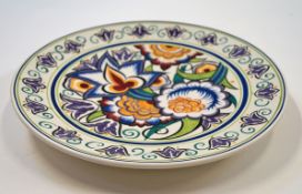 A Poole pottery plate decorated by Susan Russell with stylised flowers, printed and painted marks,