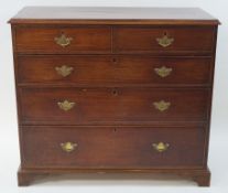 A George III mahogany chest of two short and three long drawers with brass handles and bracket feet,