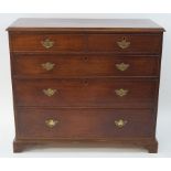 A George III mahogany chest of two short and three long drawers with brass handles and bracket feet,