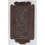 An early 20th century carved oak handing corner cabinet,