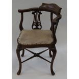 An Edwardian mahogany inlaid corner chair with pierced splats and cabriole legs linked by turned