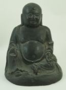 A bronze figure of Buddha seated on a domed base,