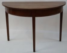 A 19th century oak demi lune side table on square tapering legs, 71cm high, 109cm wide, 53.