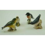 A collection of four Beswick figures of birds, comprising of a Stonechat, a Greenfinch,