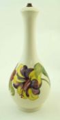 A Moorcroft table lamp base, decorated with the hibiscus pattern, impressed marks and paper label,