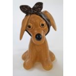 A Sylvac "Toothache" model of a dog, in a light brown matt glaze,