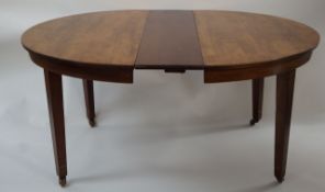 An Edwardian mahogany dining table with d ends and five loose,