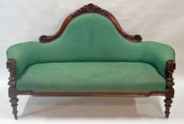 A Victorian mahogany show frame sofa with foliate carved back,