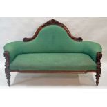 A Victorian mahogany show frame sofa with foliate carved back,