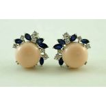 A pair of pale coral, sapphire and diamond stud earrings, the coral of approximately 14.