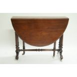 A Victorian mahogany oval drop leaf tea table, on turned legs with ceramic casters, 71cm high,