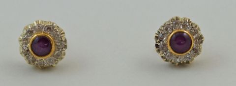 A pair of star ruby and diamond stud earrings, the rubies of approximately 5 mm diameter,