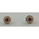 A pair of star ruby and diamond stud earrings, the rubies of approximately 5 mm diameter,