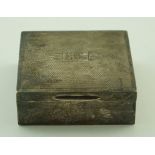 A silver mounted square cigarette box with an engine turned cover with initials GJR,