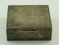 A silver mounted square cigarette box with an engine turned cover with initials GJR,