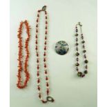 A dog's tooth coral necklace, 57 cm long, two strings of glass beads,