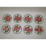 A set of eight Wemyss pottery bowls each painted with two roses with green line rims,