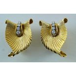 A pair of gold and diamond 1950's shaped clip earrings, of curled fan design,