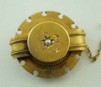 A Victorian gold brooch, of circular outline and set with a split pearl to the centre, locket back,