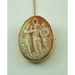 A large shell cameo brooch, carved as the Three Graces, to  a plain mount,